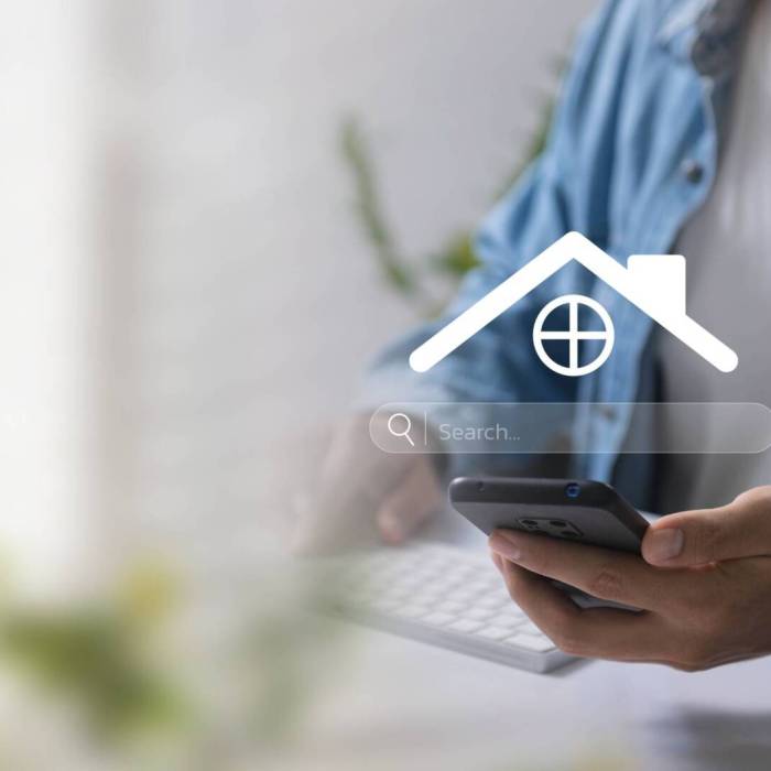 A person uses a smartphone to search for real estate online, highlighting digital home search technology. Discover Property Listings, Market Trends, and Investment for Effective Real Estate Management